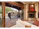 Living room with fireplace and view of backyard pool and spa at 27440 N Alma School Pkwy # 33-1, Scottsdale, AZ 85262
