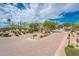 The entrance to The Rocks community features a brick road and desert landscaping at 27440 N Alma School Pkwy # 33-1, Scottsdale, AZ 85262