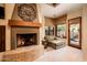 Cozy fireplace with seating area and access to patio at 27440 N Alma School Pkwy # 33-1, Scottsdale, AZ 85262