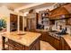 Granite kitchen island, stainless steel appliances, and custom cabinetry at 27440 N Alma School Pkwy # 33-1, Scottsdale, AZ 85262