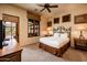 Guest bedroom with backyard view and ceiling fan at 27440 N Alma School Pkwy # 33-1, Scottsdale, AZ 85262