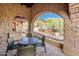 Stone patio with arched walkways and seating area at 27440 N Alma School Pkwy # 33-1, Scottsdale, AZ 85262