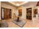 Elegant entryway with a round table, tile floors, and built-in wet bar at 27440 N Alma School Pkwy # 33-1, Scottsdale, AZ 85262