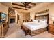 Spacious Primary bedroom with fireplace and wood beam ceiling at 27440 N Alma School Pkwy # 33-1, Scottsdale, AZ 85262