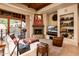 Comfortable living room with a fireplace, sectional sofa, and built-in shelving at 27440 N Alma School Pkwy # 33-1, Scottsdale, AZ 85262