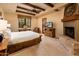 King bedroom with fireplace and access to patio at 27440 N Alma School Pkwy # 33-1, Scottsdale, AZ 85262