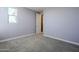 Purple-walled bedroom with door and carpet flooring at 10013 E Trent Ave, Mesa, AZ 85212