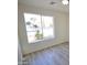 Well-lit bedroom with wood-look flooring and a view of the street at 2018 N 52Nd Dr, Phoenix, AZ 85035