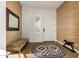Light and airy entryway with wood-look tile flooring and a bench at 17197 W Thousand Oaks St, Surprise, AZ 85388