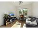 Home office featuring a comfortable couch, built-in shelving, and a workspace at 17197 W Thousand Oaks St, Surprise, AZ 85388