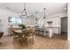Bright kitchen features an island, dining area, and hardwood floors at 17197 W Thousand Oaks St, Surprise, AZ 85388