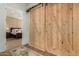 Hallway with barn door leading to bedroom at 17197 W Thousand Oaks St, Surprise, AZ 85388