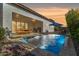 Outdoor entertainment area featuring a pool, patio furniture, and built-in grill at 17197 W Thousand Oaks St, Surprise, AZ 85388