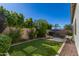 Landscaped backyard with artificial turf and a view of the pool at 17197 W Thousand Oaks St, Surprise, AZ 85388