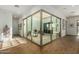 Sunlit interior room with glass walls and wood-like flooring at 17197 W Thousand Oaks St, Surprise, AZ 85388