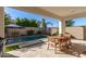 Outdoor patio with dining table and chairs overlooking a sparkling pool at 17197 W Thousand Oaks St, Surprise, AZ 85388