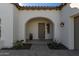 Front entry with arched entryway, modern door, and sidelights at 17197 W Thousand Oaks St, Surprise, AZ 85388