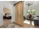 Home office with barn door entry and workspace at 17197 W Thousand Oaks St, Surprise, AZ 85388