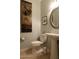 Stylish bathroom with pedestal sink, oval mirror, and decorative art at 2541 E Carob Dr, Gilbert, AZ 85298
