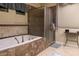 Elegant bathroom with soaking tub, shower, and double vanity at 2541 E Carob Dr, Gilbert, AZ 85298