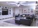 Spacious living room with large sectional sofa and built-in shelving at 2541 E Carob Dr, Gilbert, AZ 85298
