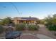 Landscaped backyard with patio, fire pit, and views of the mountains at 11255 S San Adrian Ln, Goodyear, AZ 85338