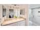 Double vanity bathroom with granite countertop and shower at 11255 S San Adrian Ln, Goodyear, AZ 85338