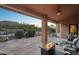 Relaxing covered patio with fire pit, overlooking a sparkling pool and mountain views at 11255 S San Adrian Ln, Goodyear, AZ 85338