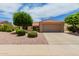 Single-story home with a terracotta roof, two-car garage, and nicely landscaped front yard at 14321 W Robertson Dr, Sun City West, AZ 85375