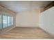 Bright living room featuring wood-look floors and large window with shutters at 6019 E Paradise Ln, Scottsdale, AZ 85254