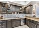 Modern kitchen featuring dark wood cabinets, granite countertops, and a glass block backsplash at 3010 E Sierra Vista Dr, Phoenix, AZ 85016