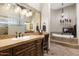 Elegant bathroom with double vanity, large mirror, and soaking tub at 4243 E Ashler Hills Dr, Cave Creek, AZ 85331