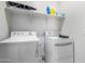Laundry room with washer, dryer, and overhead shelving at 36063 W San Alvarez Ave, Maricopa, AZ 85138