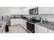Modern kitchen featuring granite countertops and stainless steel appliances at 36063 W San Alvarez Ave, Maricopa, AZ 85138