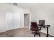 Bright home office features a built-in desk, carpeted floor, and double-door closet at 36063 W San Alvarez Ave, Maricopa, AZ 85138