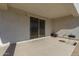 Covered patio with sliding glass door access and grill at 36063 W San Alvarez Ave, Maricopa, AZ 85138