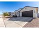 Single-story house with a two-car garage and desert landscaping at 36063 W San Alvarez Ave, Maricopa, AZ 85138