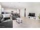 Open concept living room, kitchen, and breakfast bar at 36063 W San Alvarez Ave, Maricopa, AZ 85138