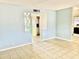 Living room with tile floors, a room divider, and kitchen view at 5522 E Colby St, Mesa, AZ 85205