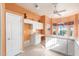 Kitchen boasts white cabinets, breakfast bar and view to backyard at 11544 W Javelina Ct, Surprise, AZ 85378