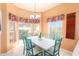 Charming dining area with teal chairs and a view to the backyard at 11544 W Javelina Ct, Surprise, AZ 85378