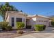 Single-story home with a two-car garage and desert landscaping at 11544 W Javelina Ct, Surprise, AZ 85378