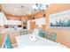 Bright dining area with teal chairs, and kitchen view at 11544 W Javelina Ct, Surprise, AZ 85378