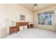 Comfortable bedroom with large window, ceiling fan and wood furniture at 11544 W Javelina Ct, Surprise, AZ 85378