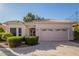 Single story home with a two car garage and well manicured landscaping at 11544 W Javelina Ct, Surprise, AZ 85378