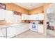White kitchen with stainless steel appliances and view to living room at 11544 W Javelina Ct, Surprise, AZ 85378