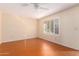 Bright bedroom featuring wood-look floors and window with shutters at 7950 E Keats Ave # 130, Mesa, AZ 85209