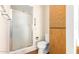 Bathroom with shower, toilet and wood cabinet at 7950 E Keats Ave # 130, Mesa, AZ 85209