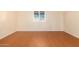 Simple bedroom featuring wood-look floors and window at 7950 E Keats Ave # 130, Mesa, AZ 85209