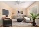 Living room with staged furniture, wood-look flooring, and large window with shutters at 7950 E Keats Ave # 130, Mesa, AZ 85209